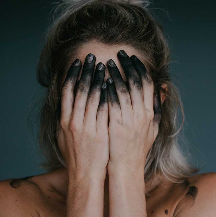 Woman with Black Fingers Covering her Face Woman with Black Fingers Covering her Face